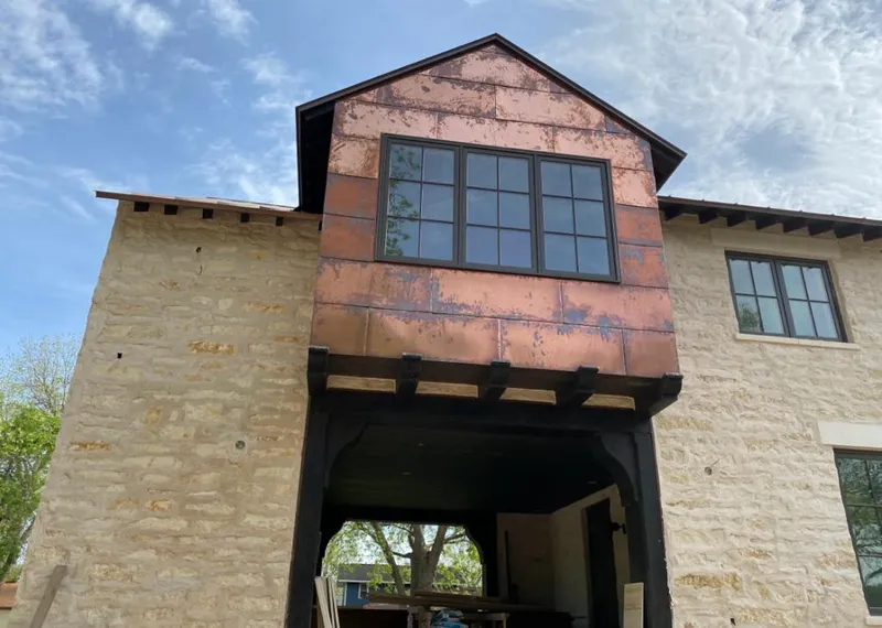 Copper metal panel facade on a stone building for Metal Roof Coating in Box Elder